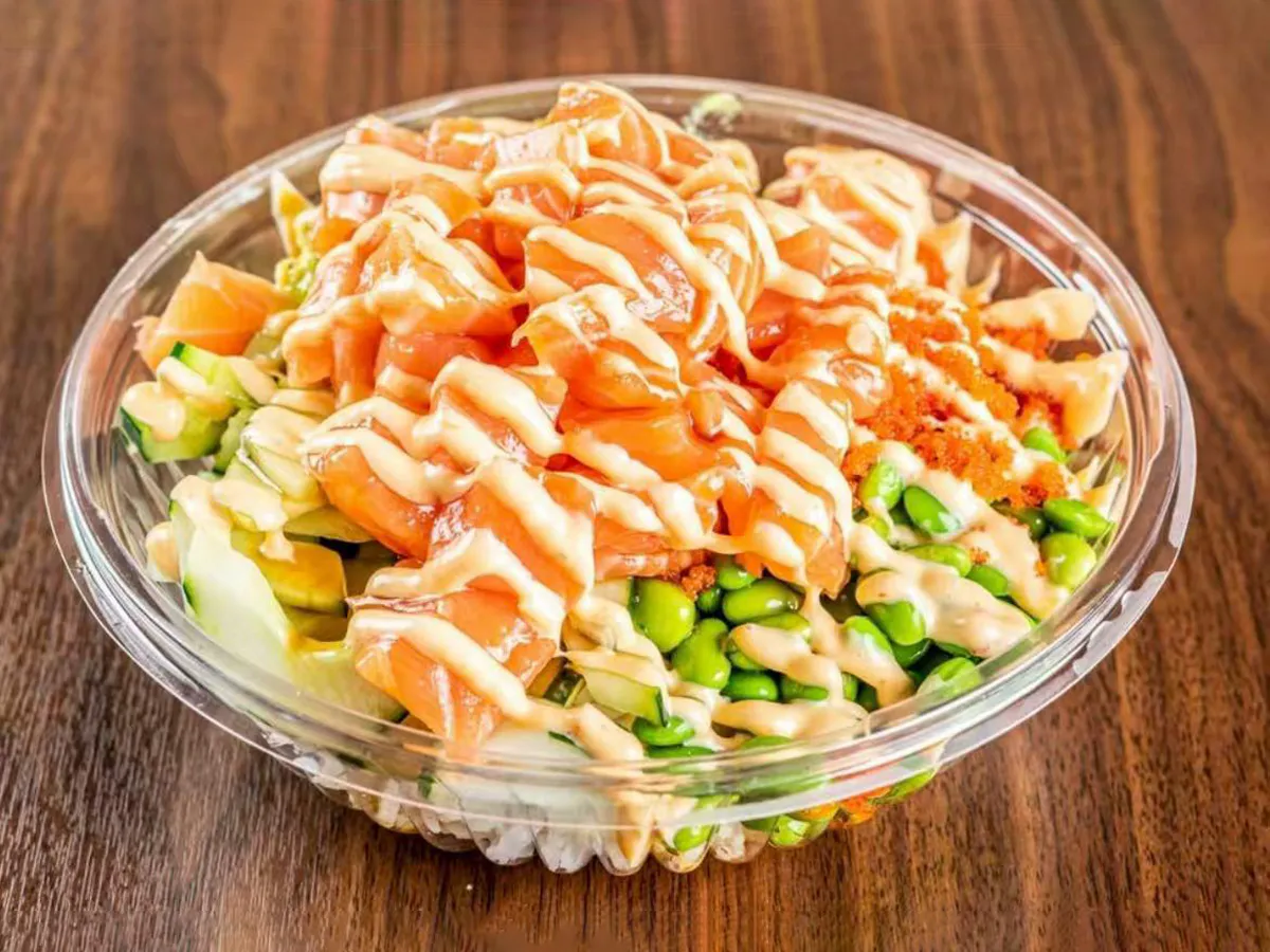 Creamy salmon poke bowl with edamame and sauce at Lin Poke, a Hawaiian Poke Bowl Restaurant in Clearwater